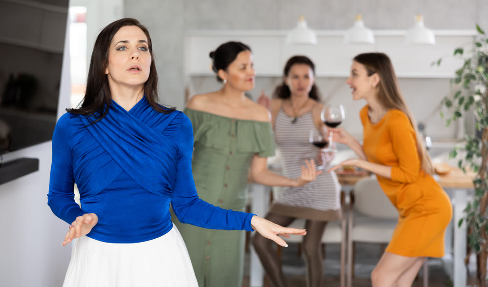 Expressive brunette in blue dancing at joyful house party