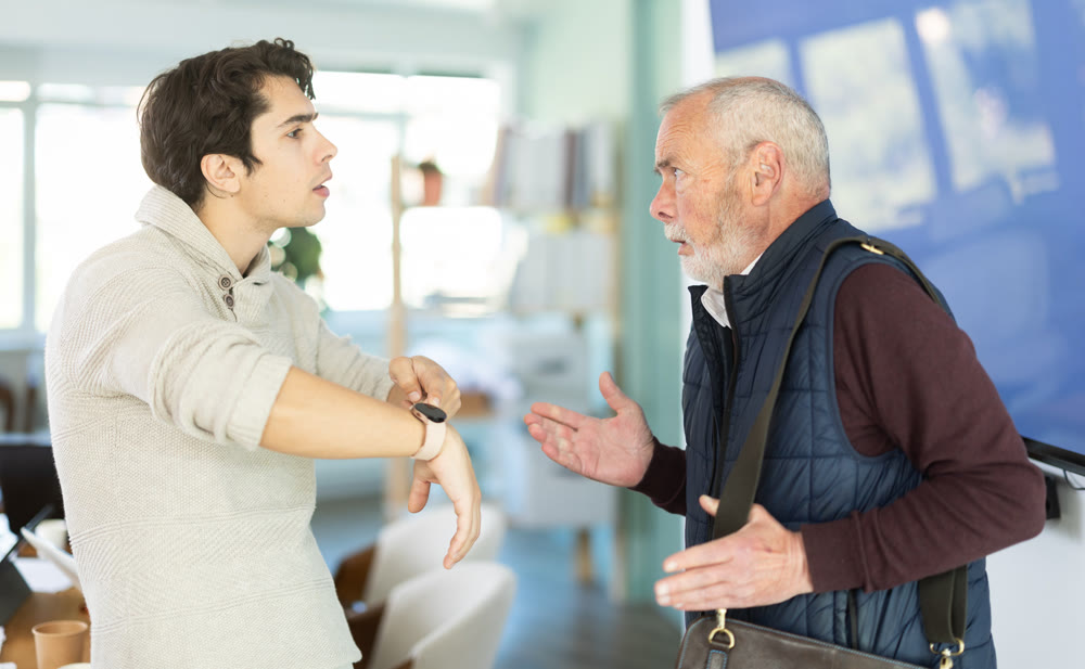 Upset senior man employee of company quits job, and guy manager shouts after him.