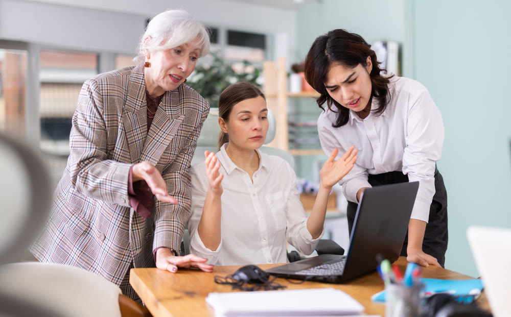 Group of women are shouting at female colleague.
