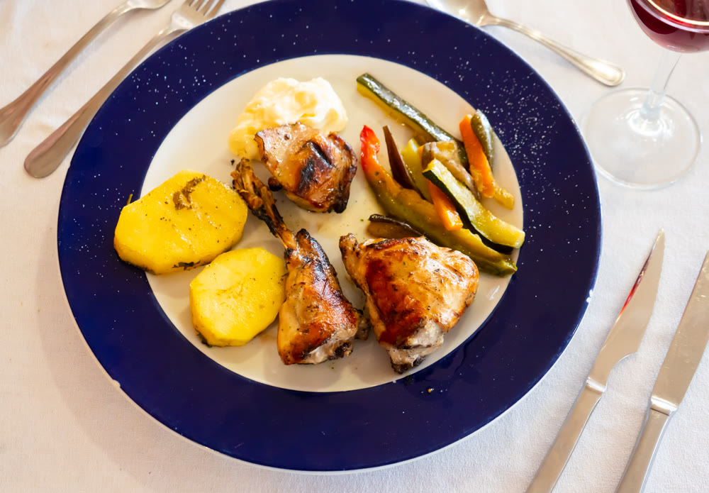 Rabbit meat with vegetables served on plate