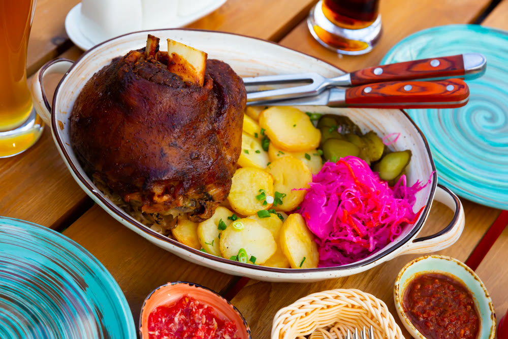 Roasted pork knuckle with potato and pickles