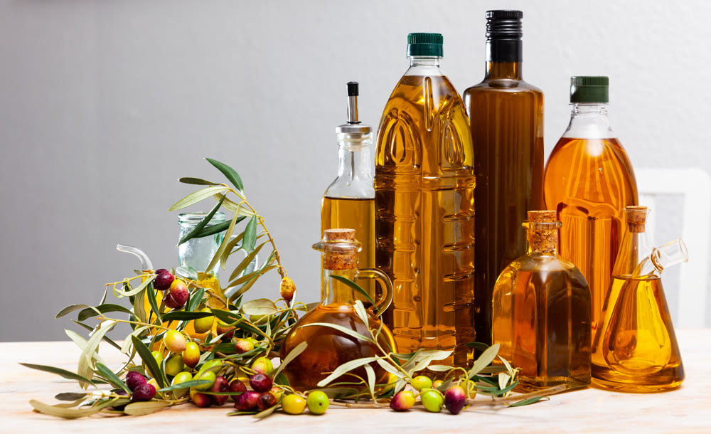 Olive oil in bottles on wooden table