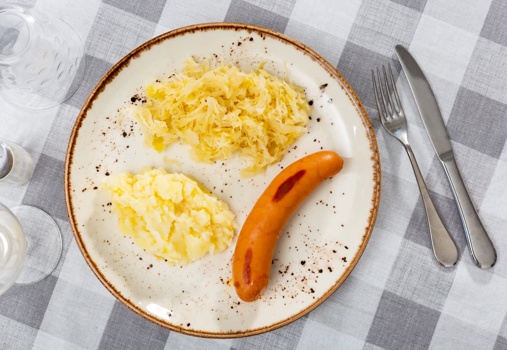Sausages served with potatoes and cabbage