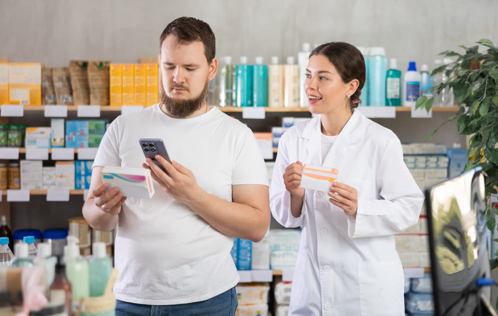 Man buyer scans pills qr code with woman pharmacist