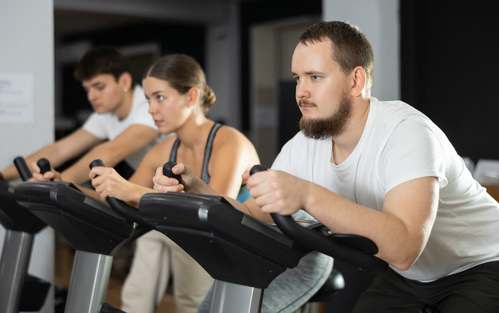 Man is exercising on an exercise bike