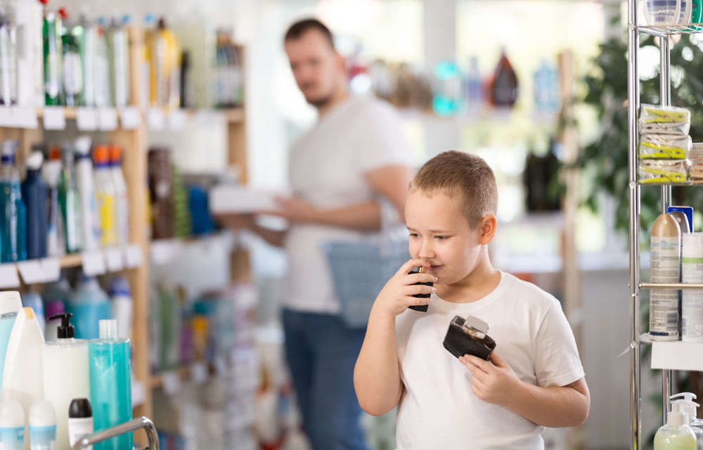 Boy chooses perfume in household chemicals store