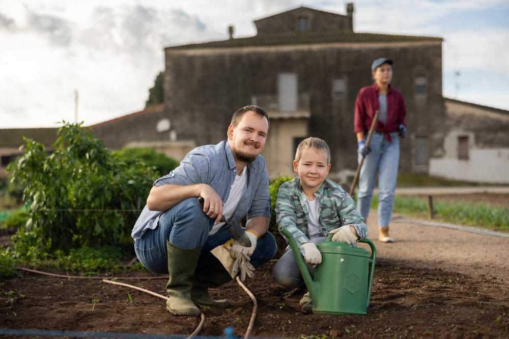 Man and his son planting seeds on a farm