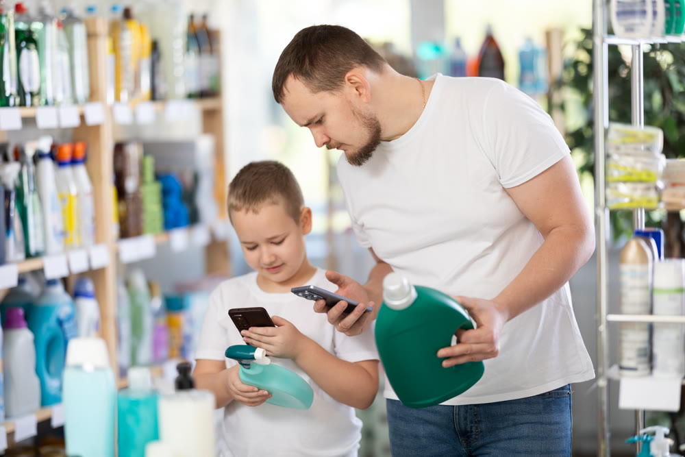 Dad and son scan barcode on packaging of laundry conditioner