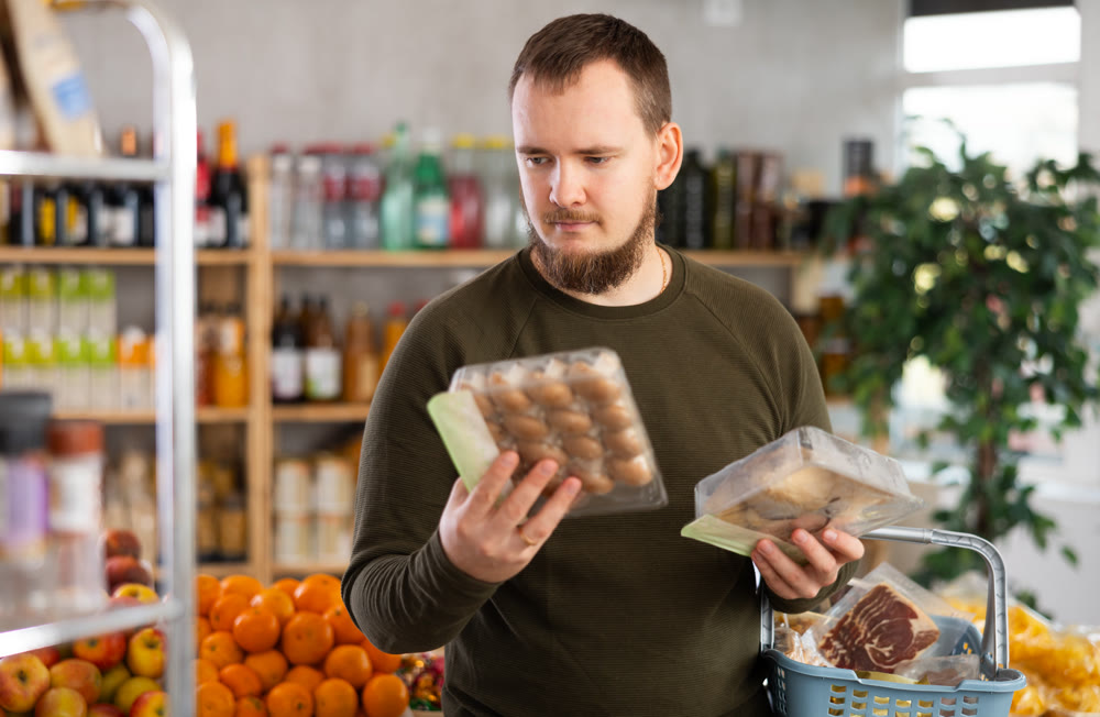 Man choosing mushrooms in the store