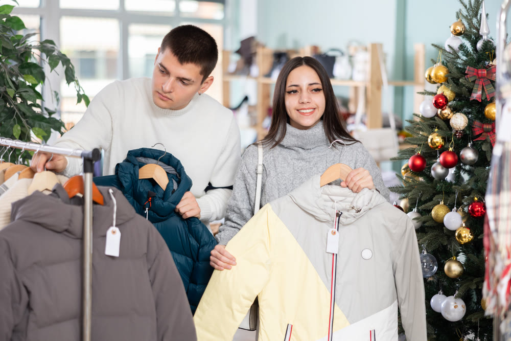Couple customer choose down jacket, New Year atmosphere
