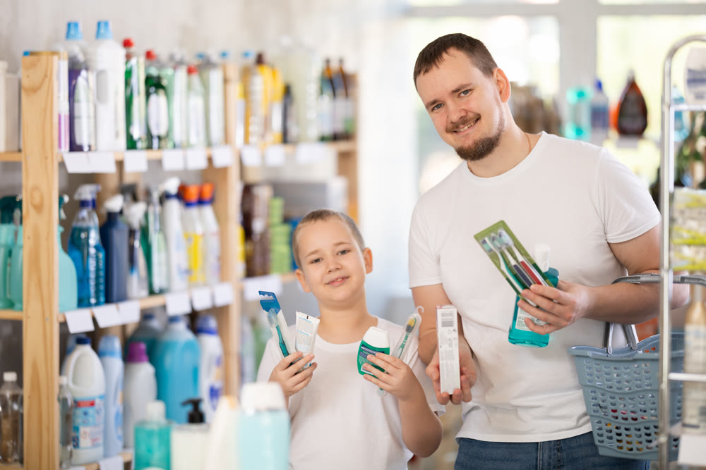 Man and boy choosing dental care products