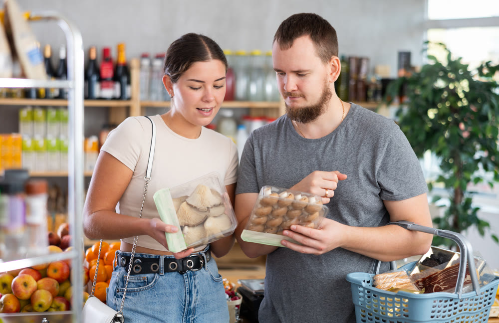 Couple choosing mushrooms in the store