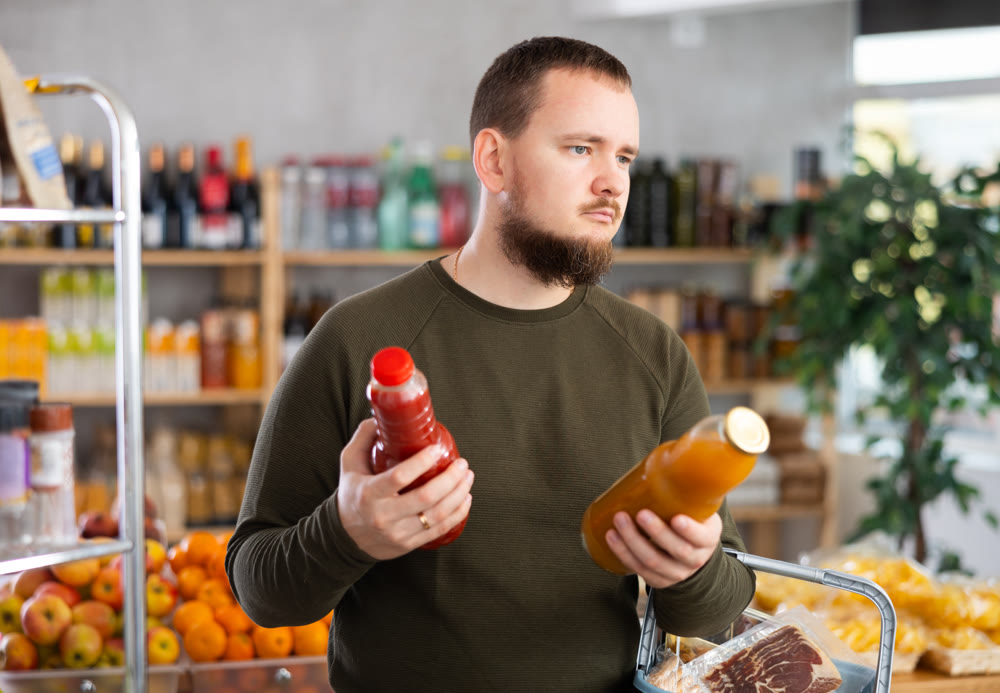 Man choosing juice in the store