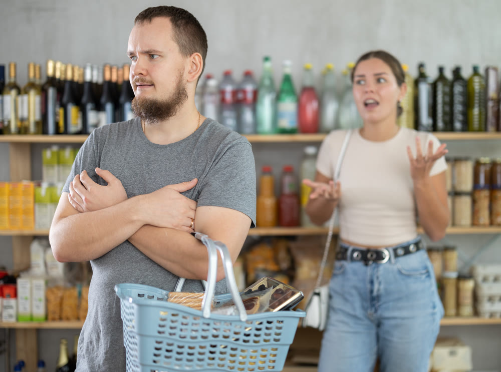 Man and woman quarrel in supermarket - they shout at each other