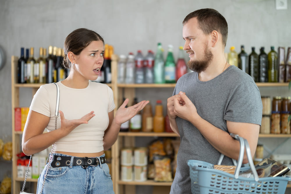 Wife and husband shout at each other, insult and accuse, express dissatisfaction