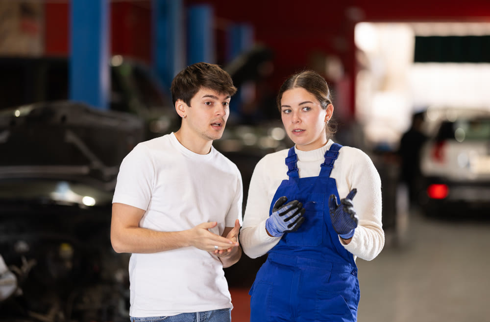 guy consults with a car service worker