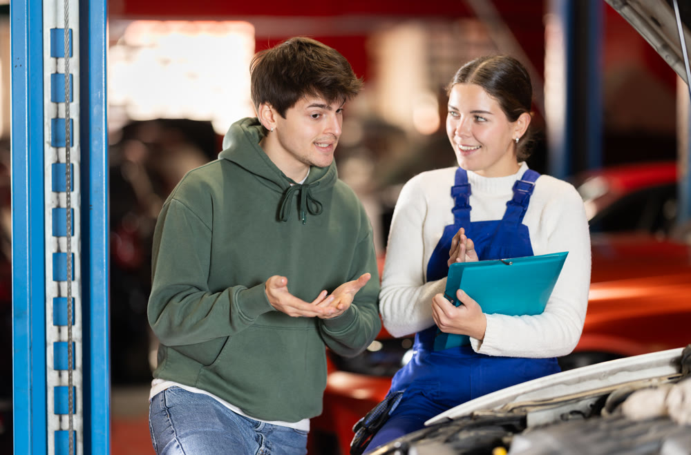 male client consults with a mechanic to repair a car