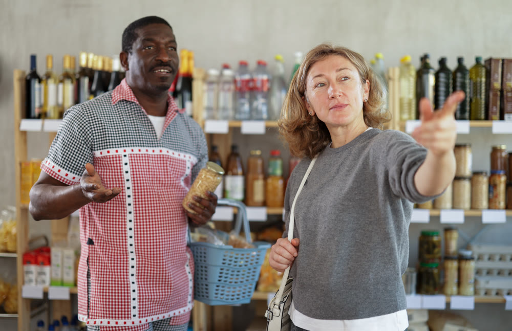 Couple man and woman choosing food in grocery store