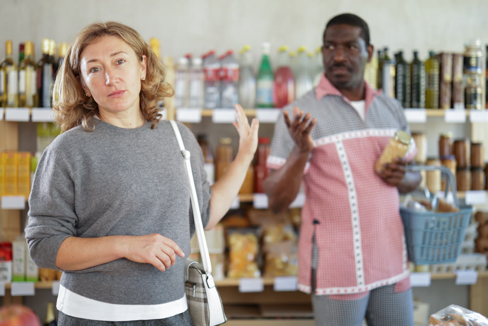 Adult man quarrels with woman in grocery store