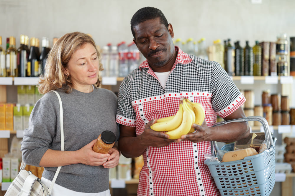 Couple man and woman choosing lentils and bananas