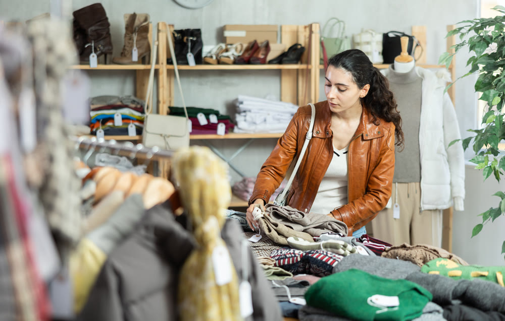 Armenian woman choosing pants and pants in the store