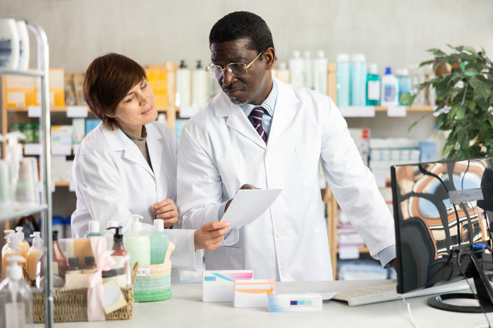 Woman and African man pharmacists at PC