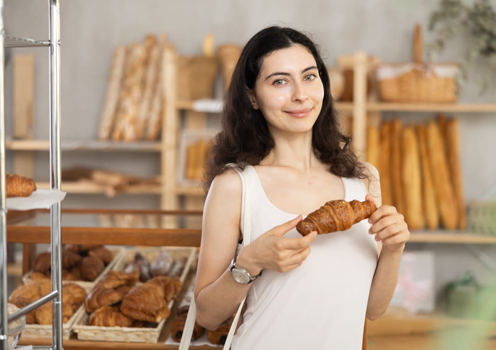 Young woman with courassan in bakery