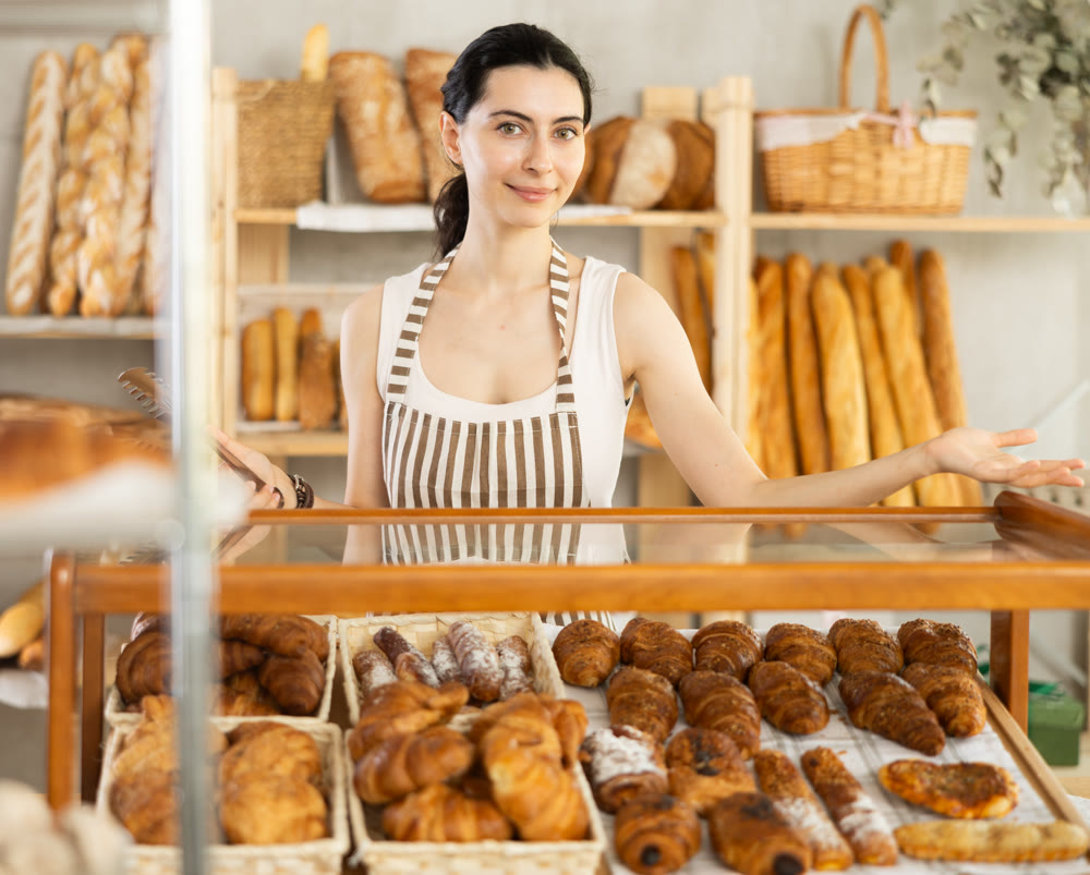 Armenian young woman work selling in family bakery shop