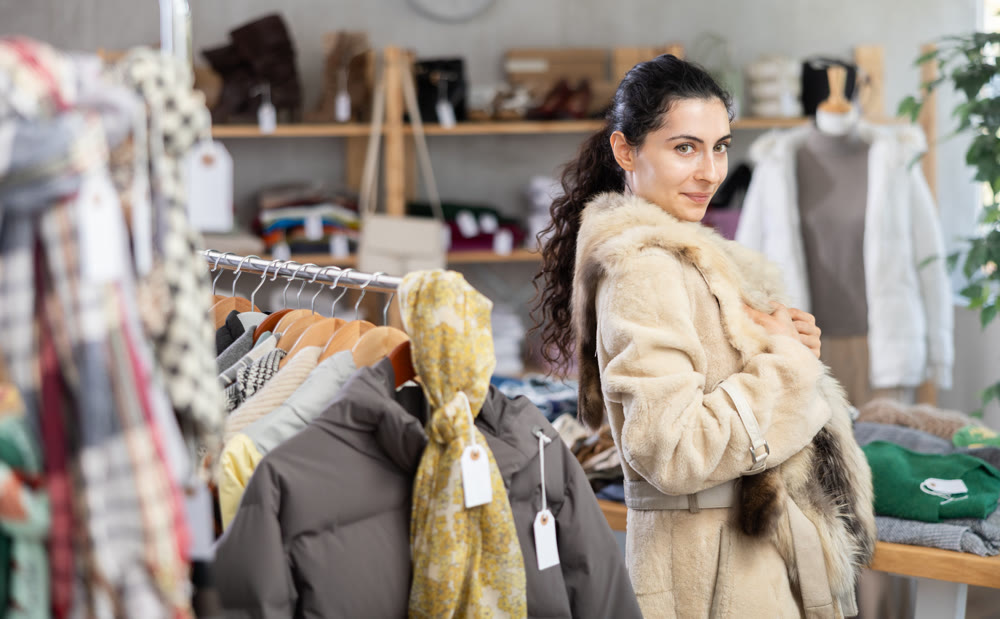Armenian woman trying on a fur coat in a store