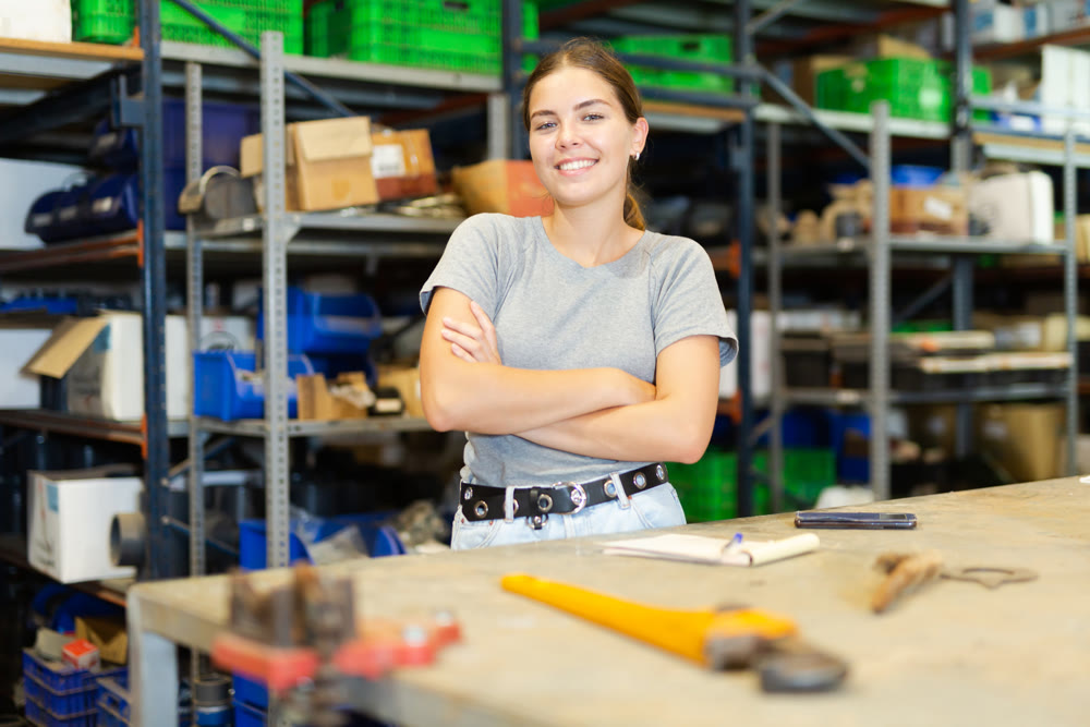 Young smiling girl posing at workplace