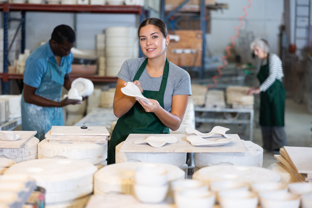 Young woman potter with new crafted decorative plates
