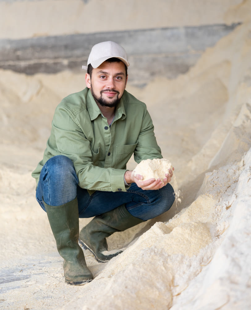 Man farmer checking quality of maize flour