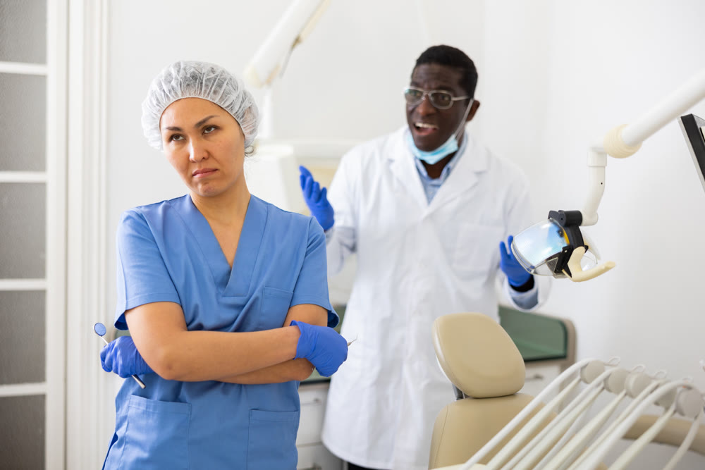 Doctor dentist is dissatisfied with the work of nurse