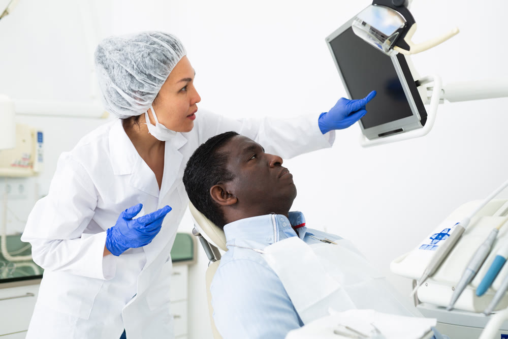 Doctor dentist shows patient an x-ray