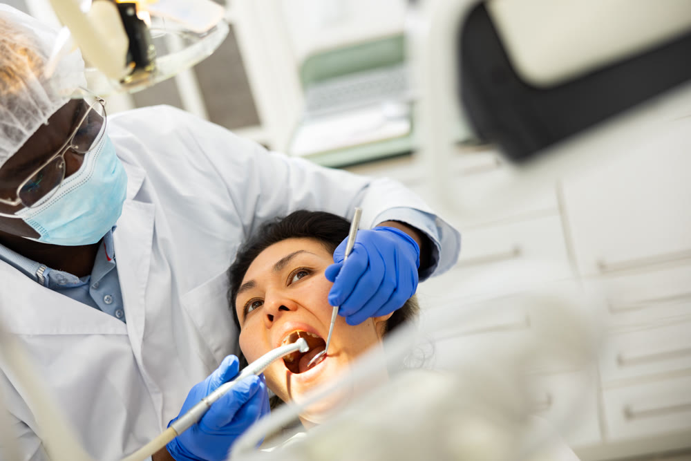 Female patient during dental treatment in dentist office