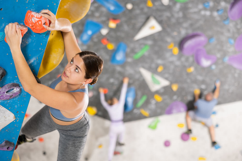 Sports woman on climbing wall without special safety equipment
