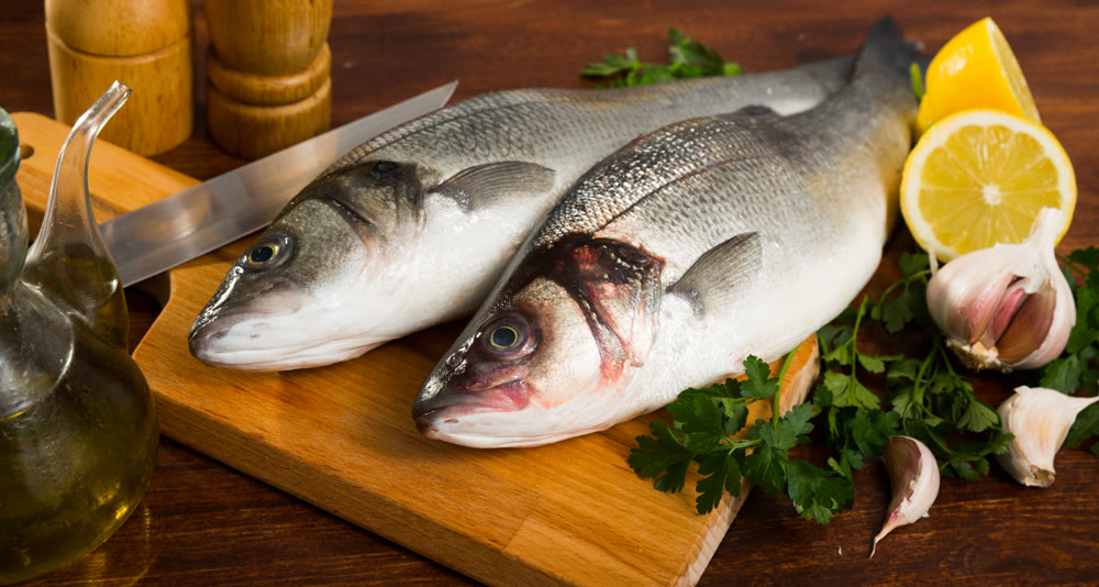 Two raw sea bass fish