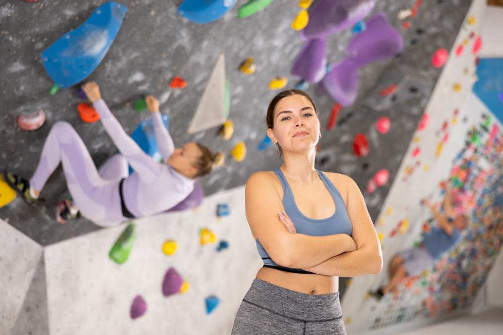 Young woman posing on climbing wall