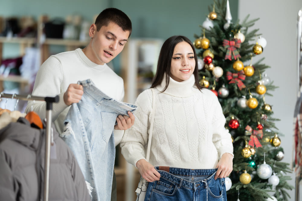 Young couple choosing jeans in store