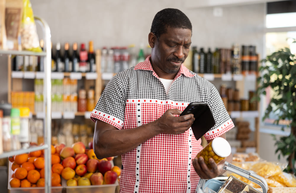 Adult man scanning qr code of olives