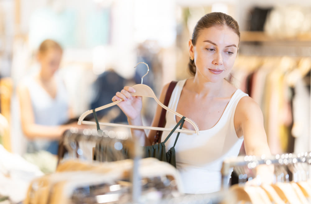 Woman choosing a dress in a clothing store