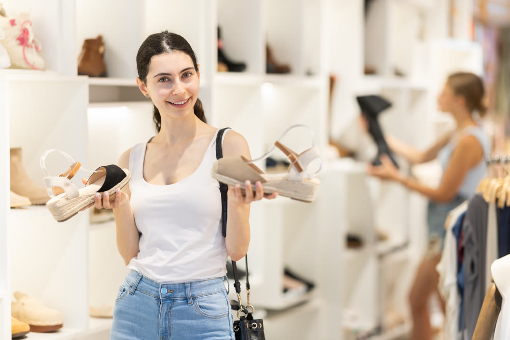 Young woman choosing shoes in a store
