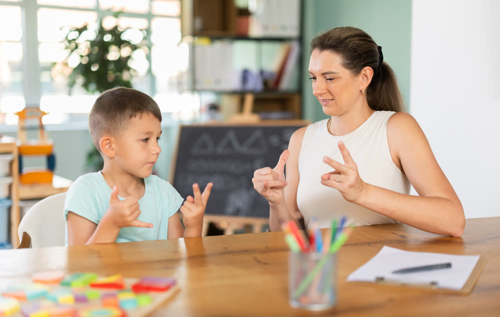 Child psychologist shows certain number of fingers, and boy repeats