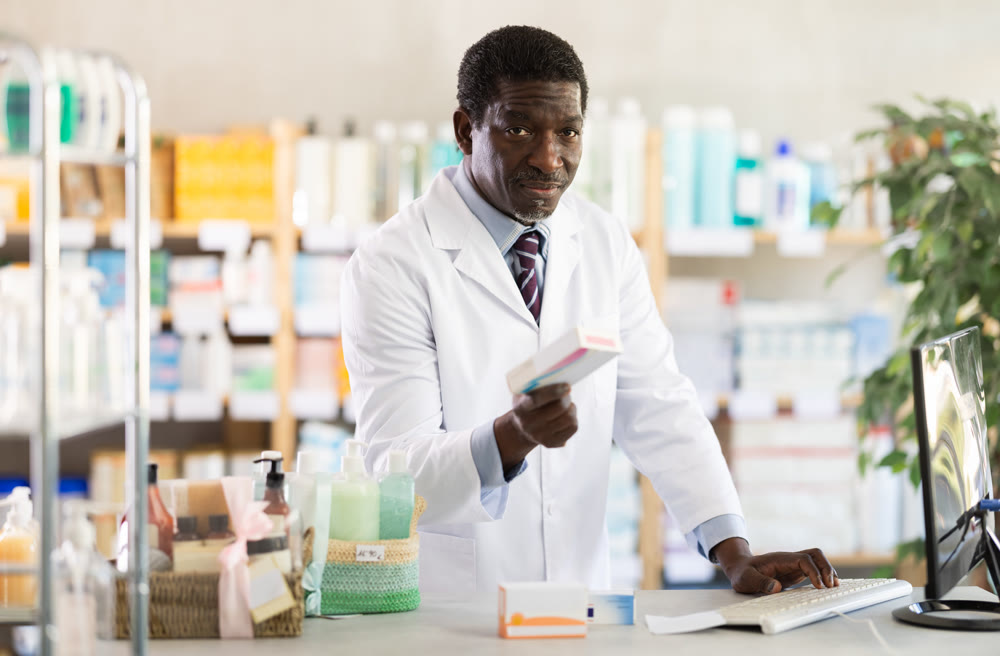 Pharmacist checking stock of medicines, offering to customer at pharmacy