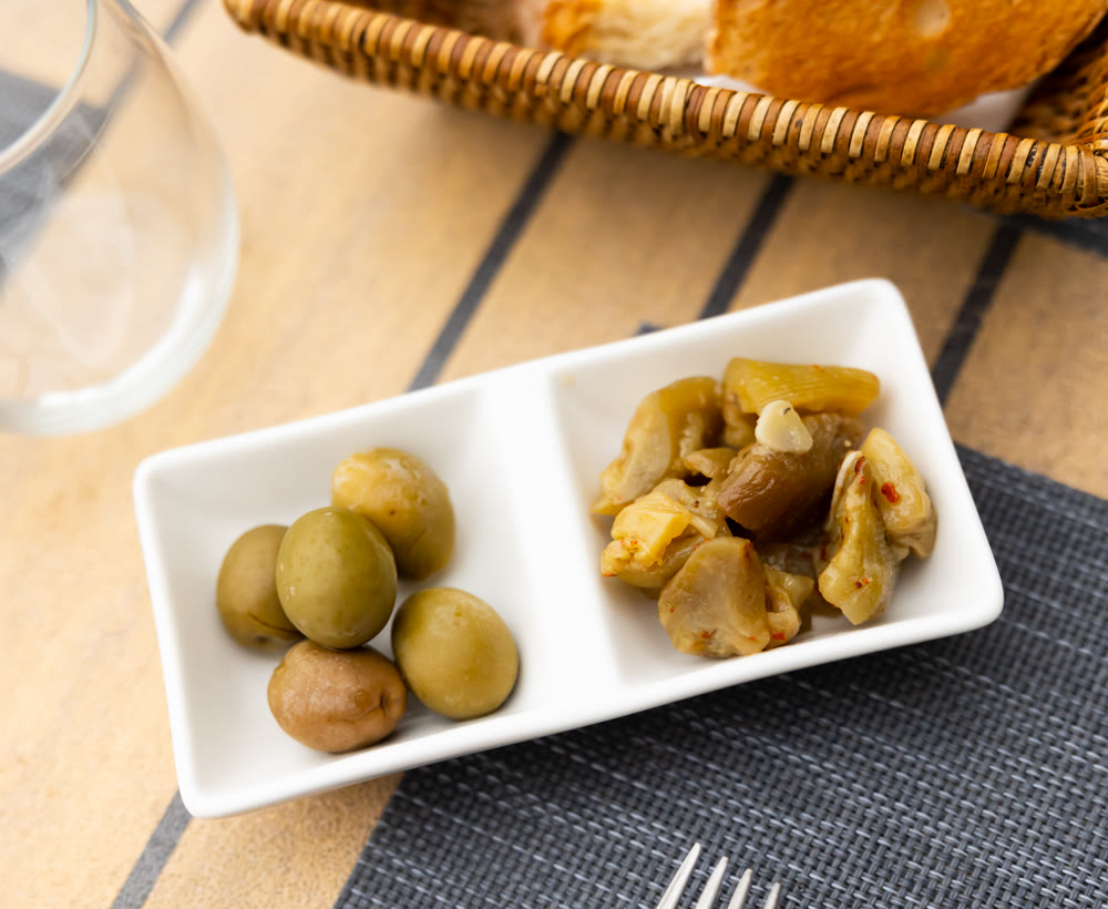 Green pickled olives and chopped spicy marinated eggplant