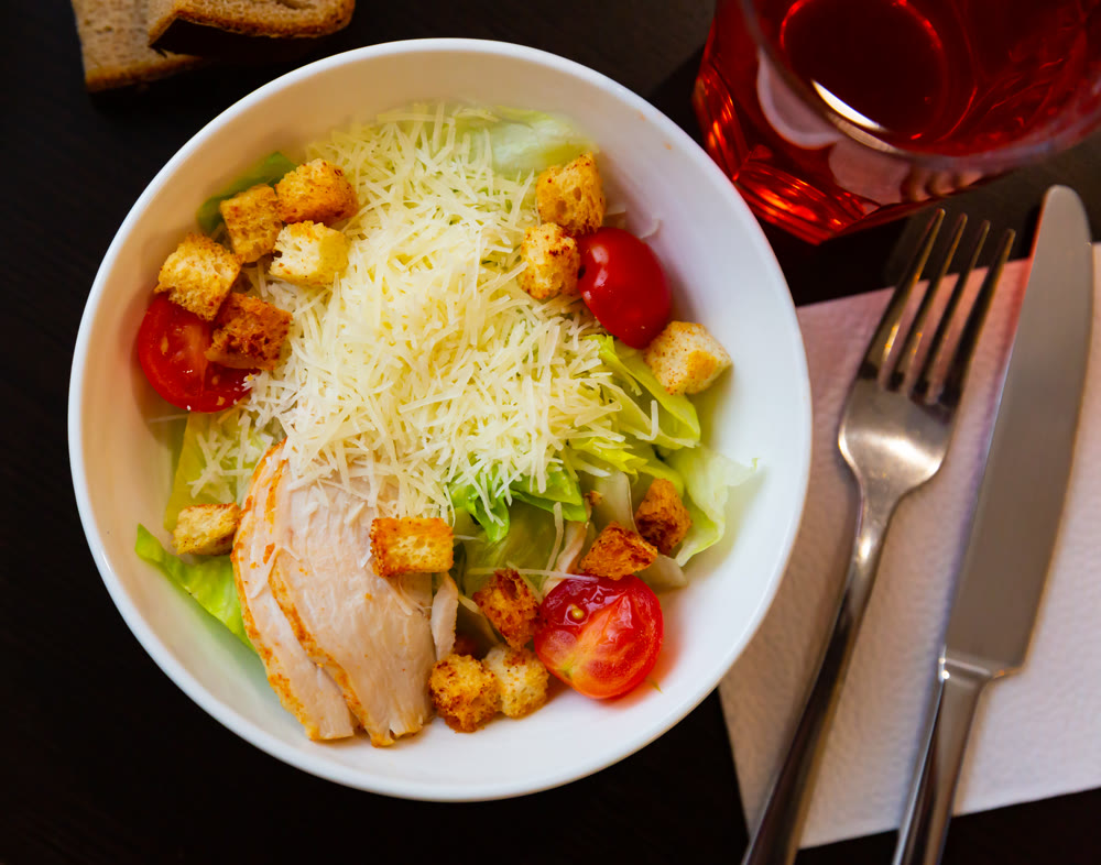 Chicken Caesar salad with tomatoes and cheese