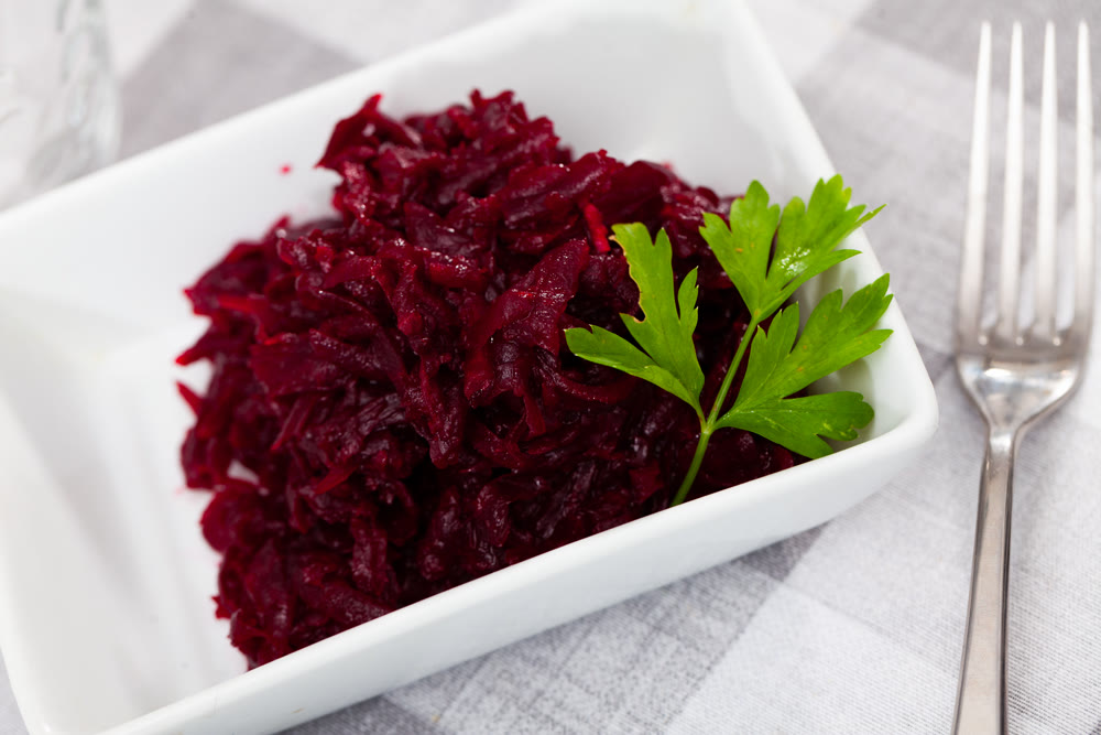 Salad of grated boiled beets with olive oil and greens