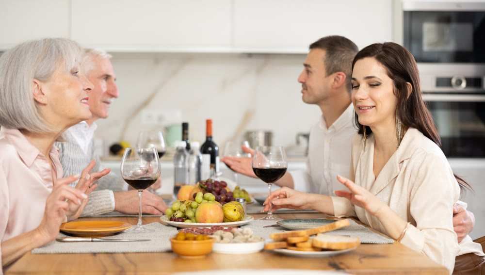 Daughter-in-law and mother-in-law talking friendly at family dinner