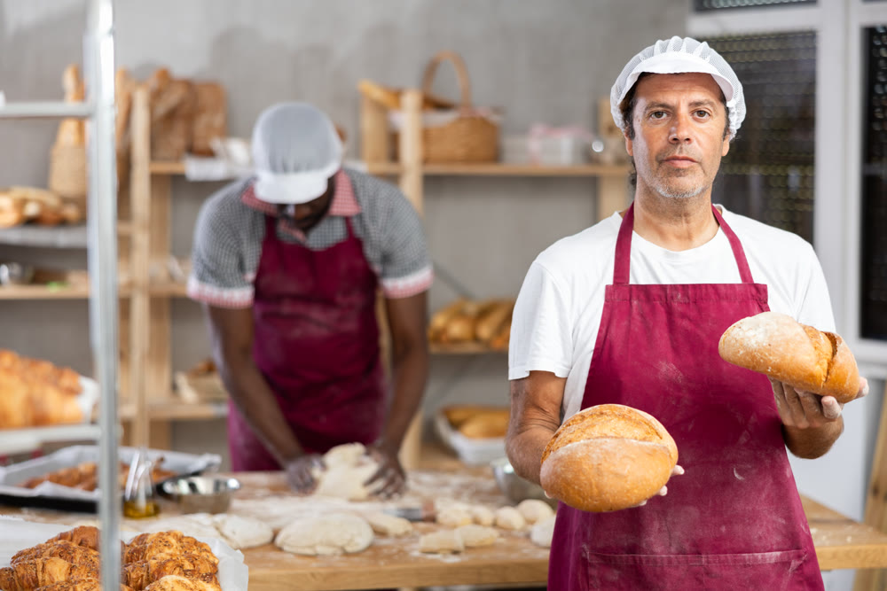 Adult man baker with homemade bread