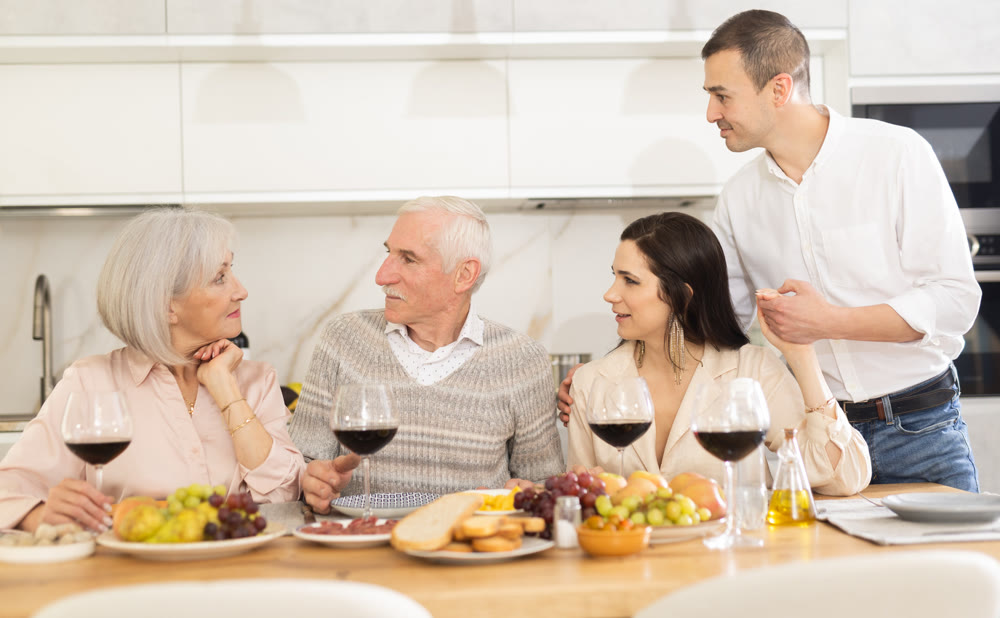 Elderly parents with daughter and son-in-law enjoying dinner